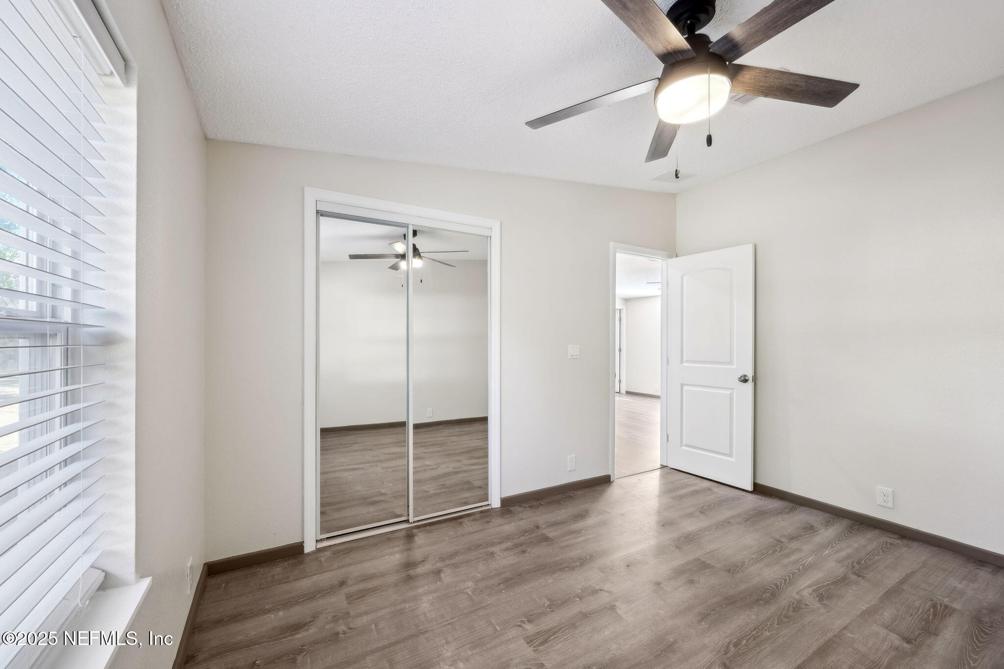 6034 Leona Padgett Road Jacksonville, FL 32234 - Photo 26 of 37 wooden floor in an empty room with a window
