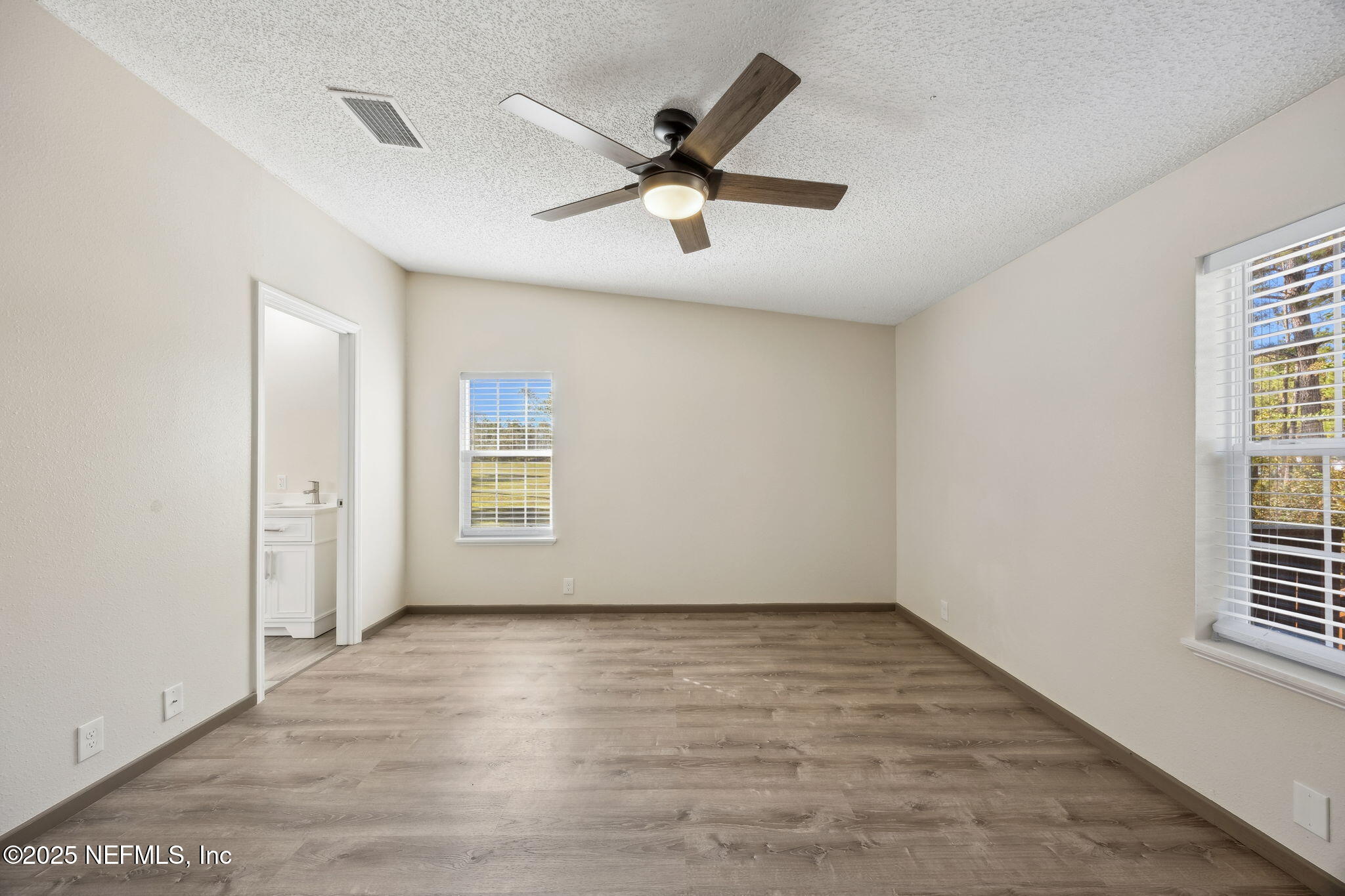 6034 Leona Padgett Road Jacksonville, FL 32234 - Photo 27 of 37 wooden floor in an empty room with a window