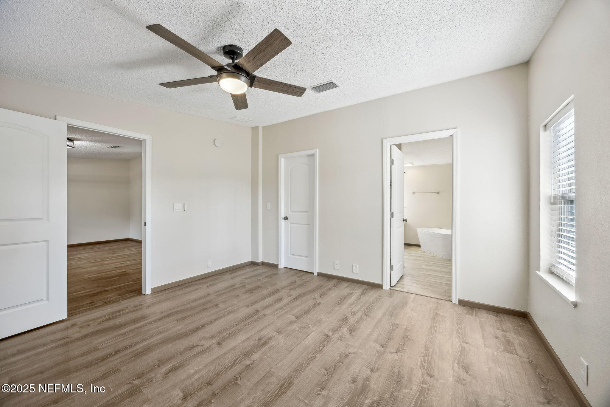 6034 Leona Padgett Road Jacksonville, FL 32234 - Photo 29 of 37 wooden floor in an empty room with a window