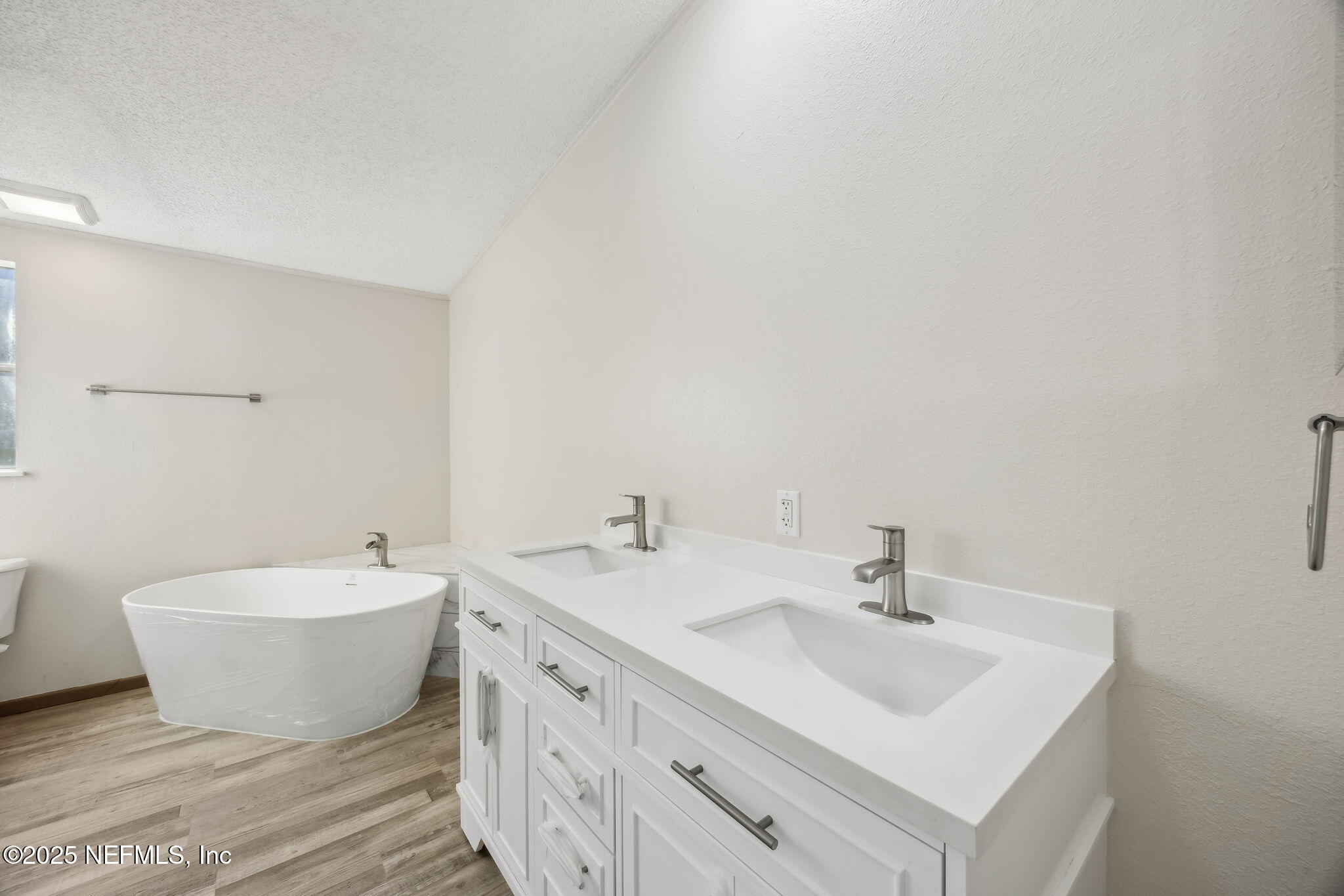 6034 Leona Padgett Road Jacksonville, FL 32234 - Photo 31 of 37 a bathroom with a double vanity sink mirror and bathtub