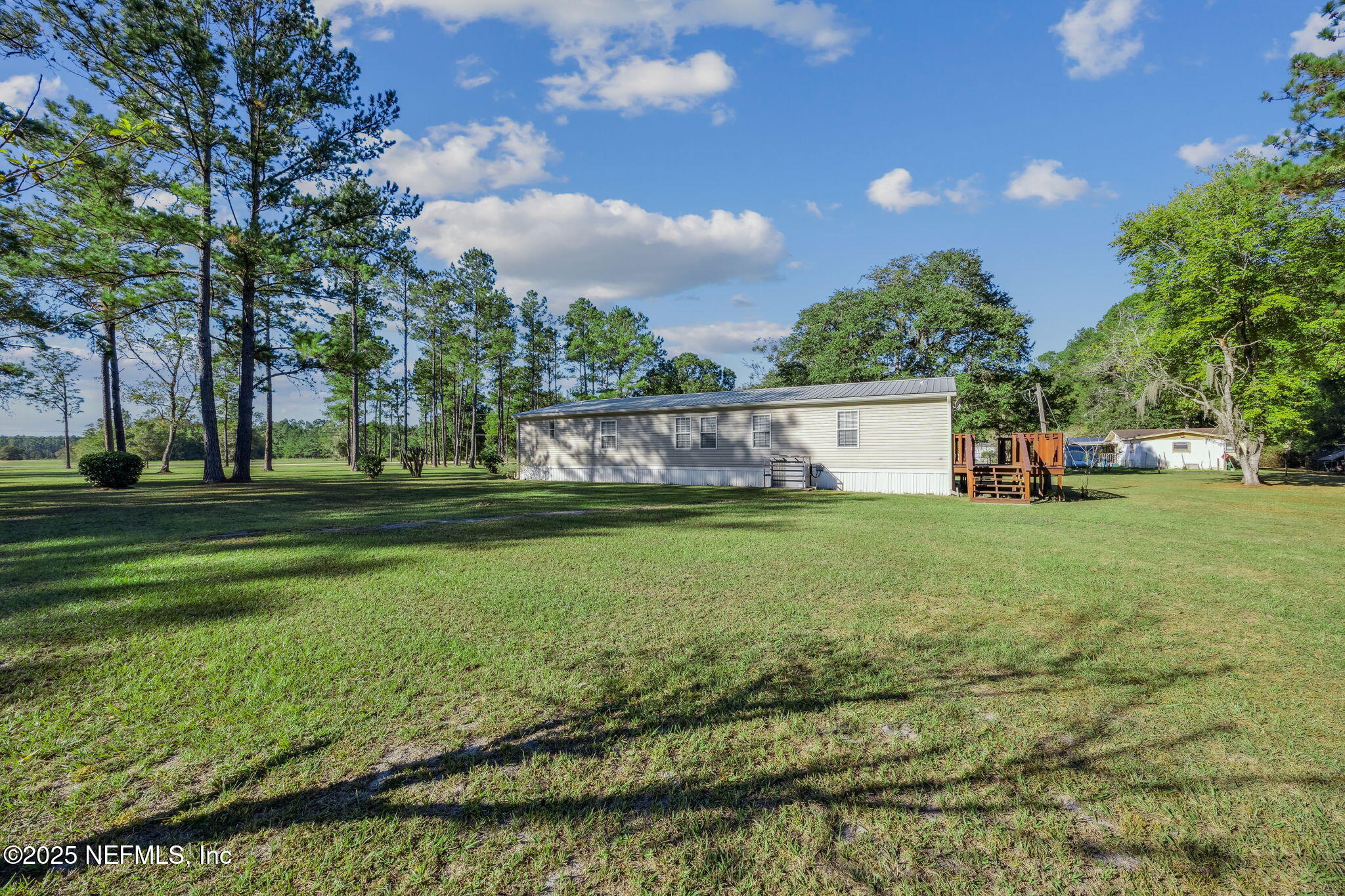 6034 Leona Padgett Road Jacksonville, FL 32234 - Photo 36 of 37 a view of a house with a big yard