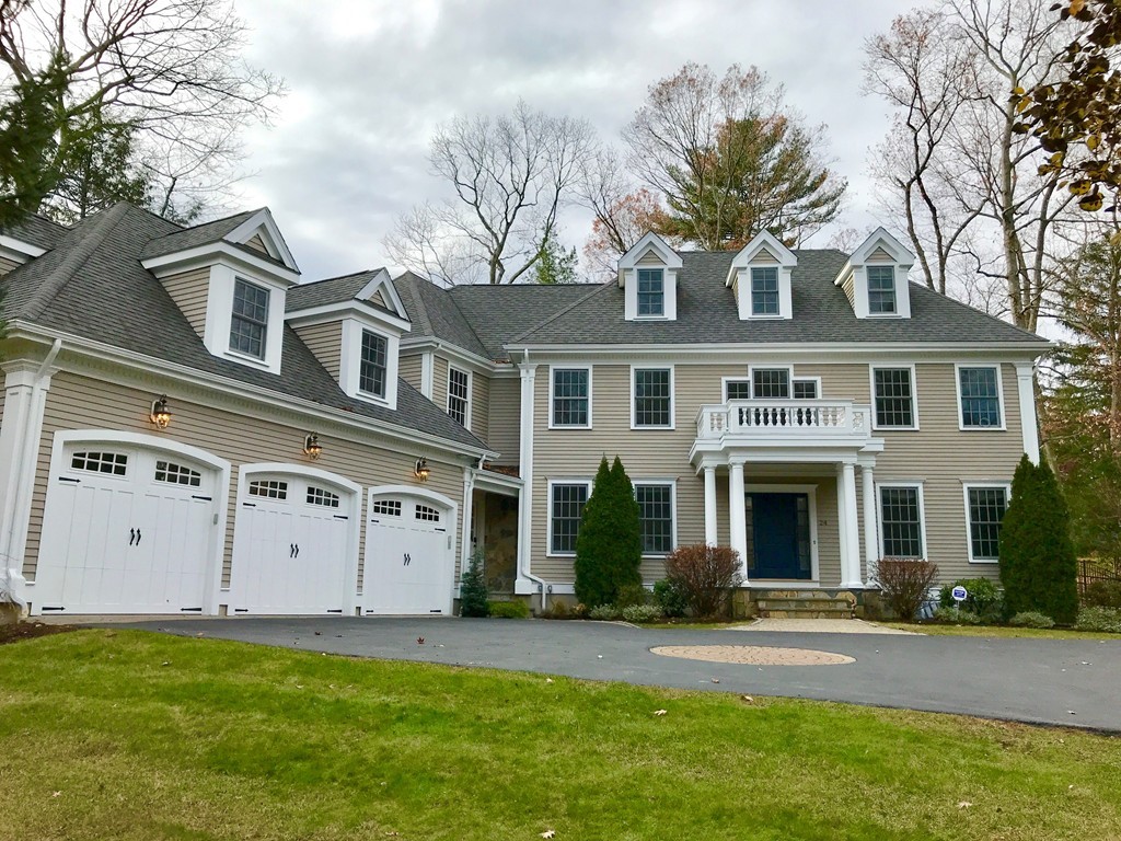 24 Audubon Road Wellesley, MA 02481 - Photo 1 of 19 a view of a white house with a large windows and a yard with plants and large trees