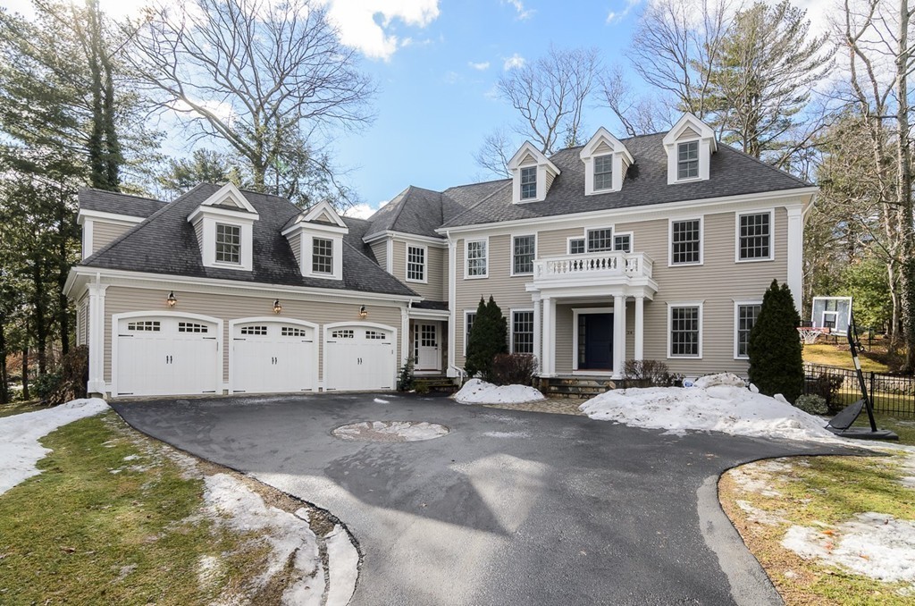 24 Audubon Road Wellesley, MA 02481 - Photo 19 of 19 a view of a white house with large windows next to a yard