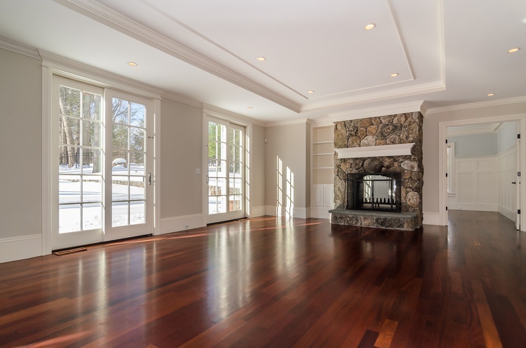 24 Audubon Road Wellesley, MA 02481 - Photo 7 of 19 an empty room with wooden floor and a fireplace