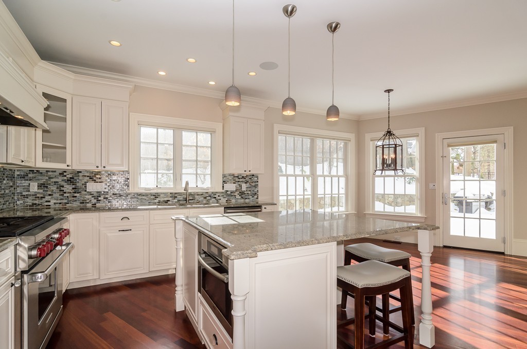 24 Audubon Road Wellesley, MA 02481 - Photo 10 of 19 a kitchen with granite countertop a stove a sink a dining table and chairs