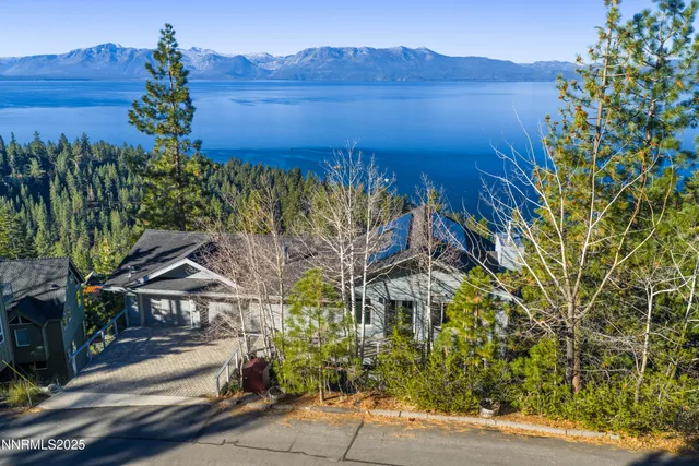 a view of a house with a tree in front of it