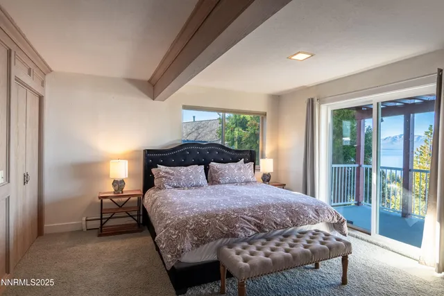 a bedroom with a bed and glass door