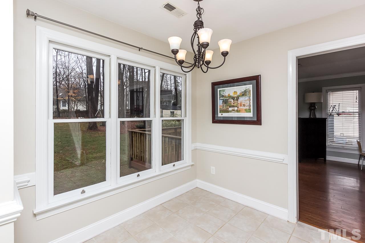 11916 Radner Way Raleigh, NC 27613 - Photo 11 of 29 a view of a big room with windows chandelier and glass door