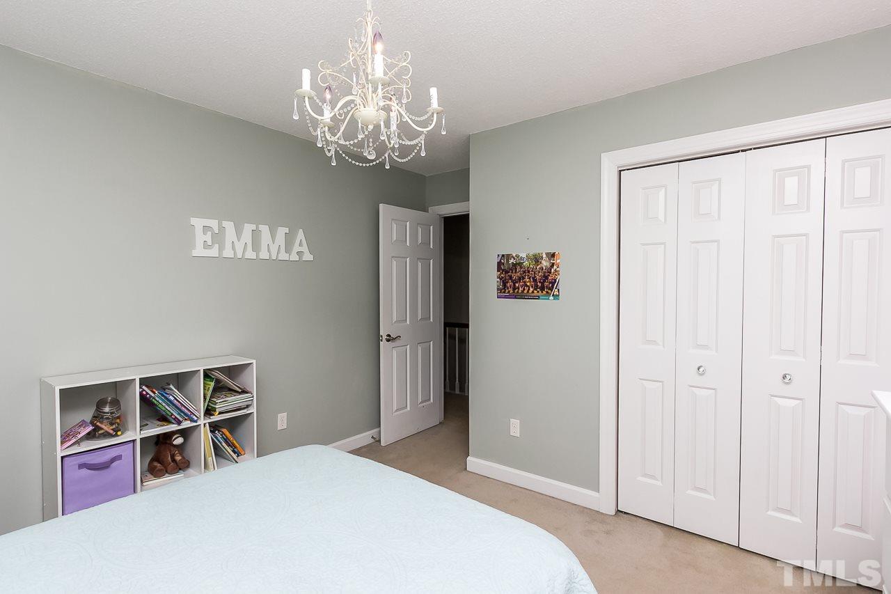 11916 Radner Way Raleigh, NC 27613 - Photo 15 of 29 a spacious bedroom with a bed and a chandelier