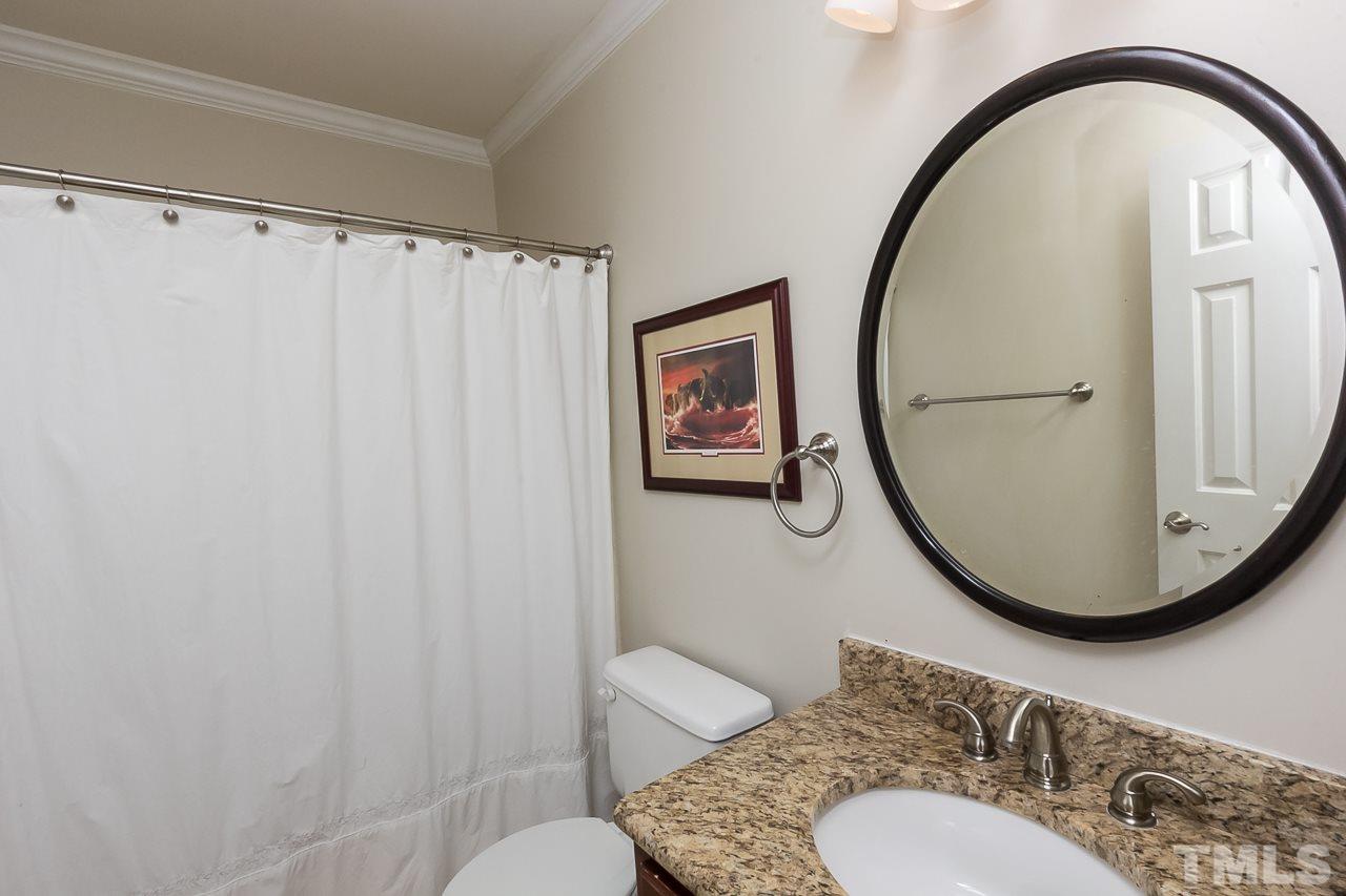 11916 Radner Way Raleigh, NC 27613 - Photo 17 of 29 a bathroom with a toilet a sink and a mirror
