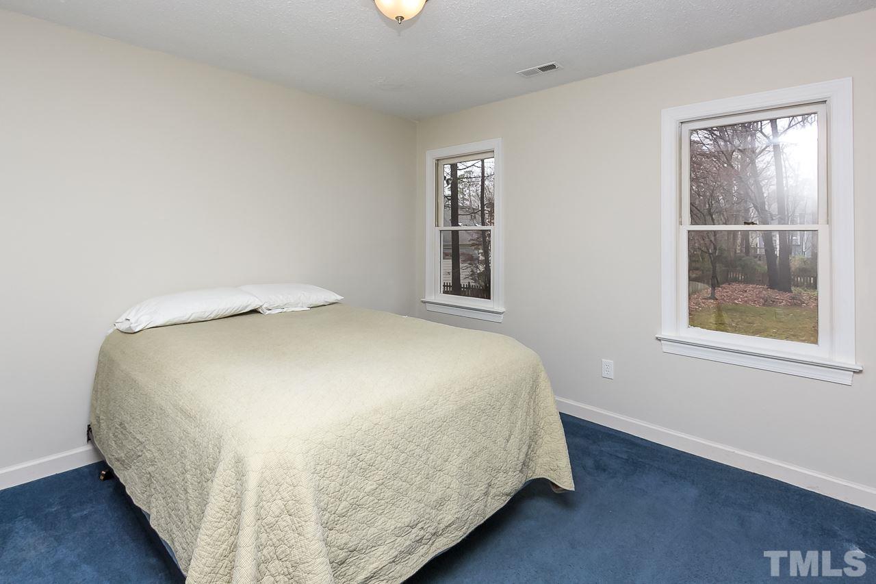11916 Radner Way Raleigh, NC 27613 - Photo 18 of 29 a large bed sitting in a bedroom next to a window