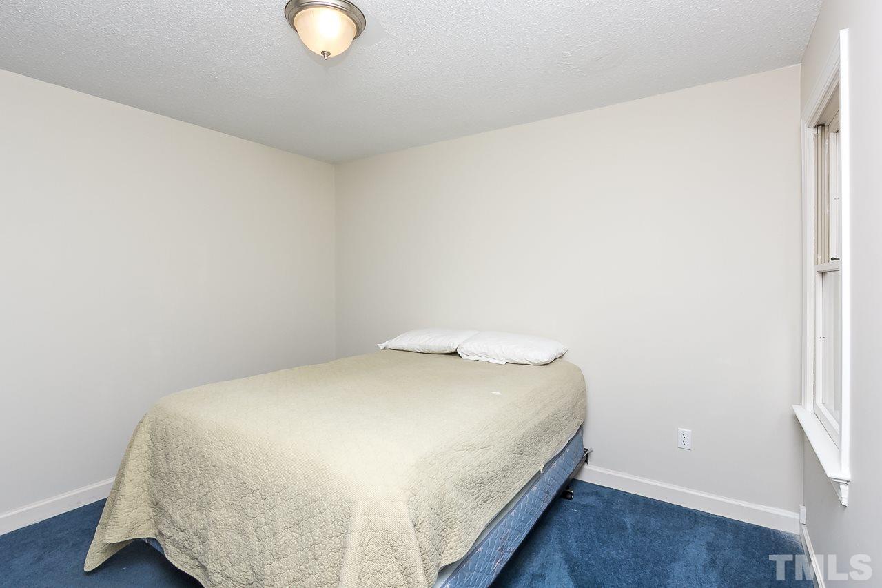 11916 Radner Way Raleigh, NC 27613 - Photo 19 of 29 a bedroom with a bed and a window