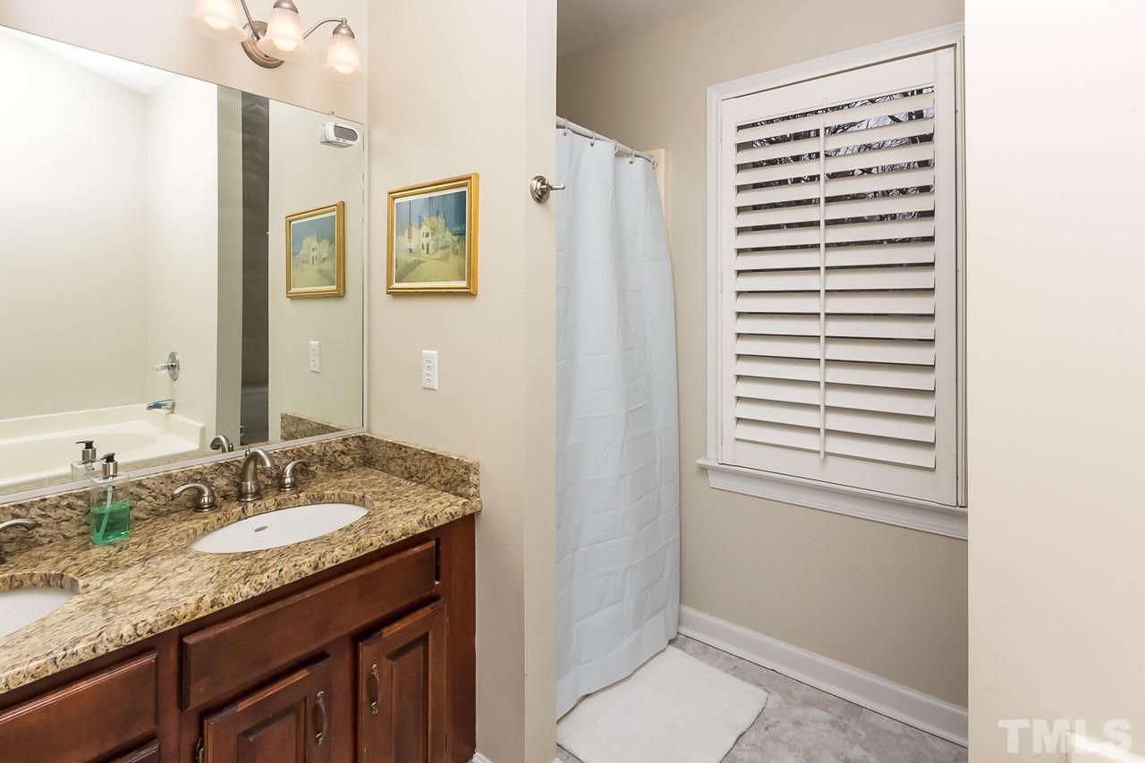 11916 Radner Way Raleigh, NC 27613 - Photo 20 of 29 a bathroom with a granite countertop sink and a mirror