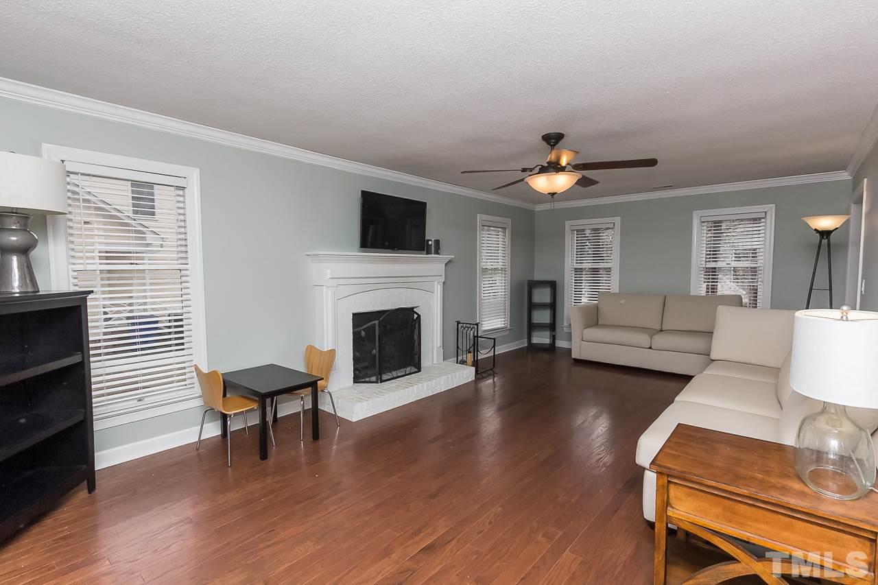11916 Radner Way Raleigh, NC 27613 - Photo 3 of 29 a living room with furniture and a fireplace