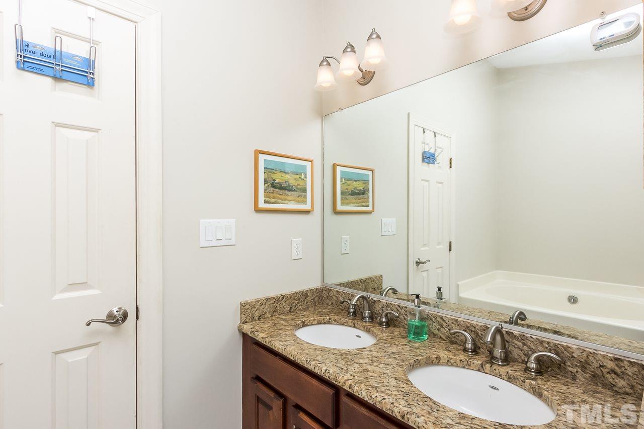 11916 Radner Way Raleigh, NC 27613 - Photo 21 of 29 a bathroom with a granite countertop sink and a mirror