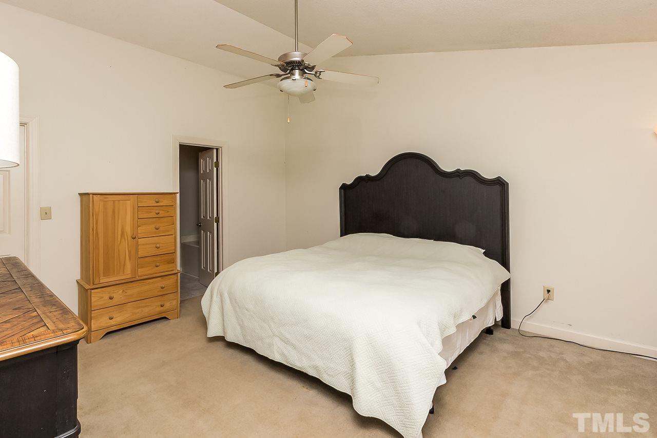 11916 Radner Way Raleigh, NC 27613 - Photo 22 of 29 a bed sitting in a bedroom next to a window