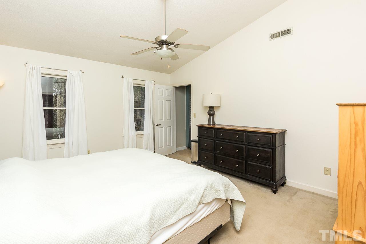 11916 Radner Way Raleigh, NC 27613 - Photo 23 of 29 a bedroom with a bed and cabinets