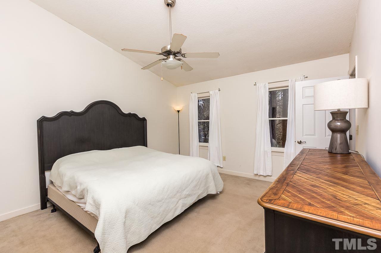 11916 Radner Way Raleigh, NC 27613 - Photo 24 of 29 a bedroom with a bed and wooden floor
