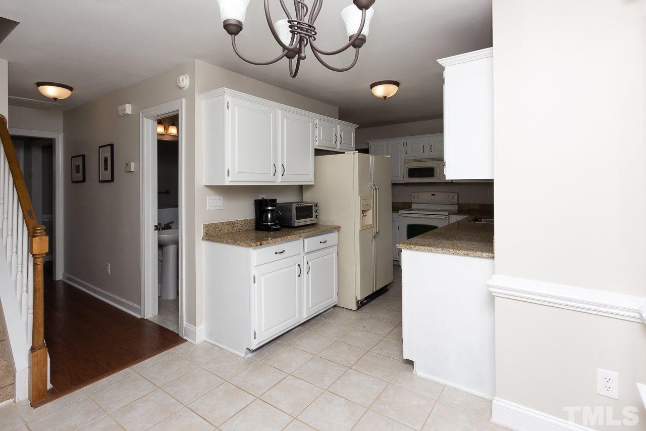 11916 Radner Way Raleigh, NC 27613 - Photo 7 of 29 a kitchen with stainless steel appliances a refrigerator sink and cabinets