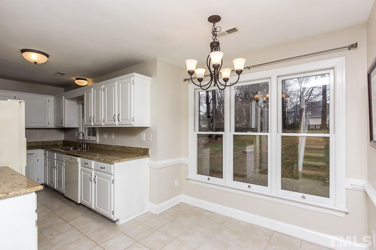 11916 Radner Way Raleigh, NC 27613 - Photo 8 of 29 a kitchen with stainless steel appliances granite countertop a stove and a sink