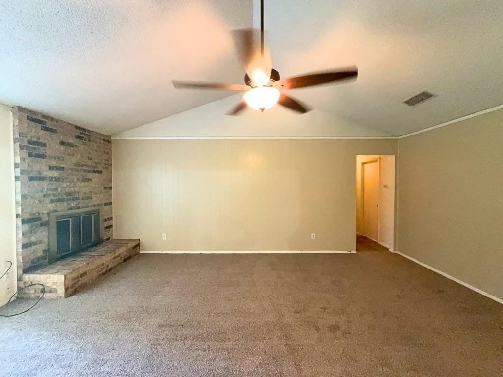 1613 Edgehill Road Benbrook, TX 76126 - Photo 3 of 22 an empty room with windows and fan