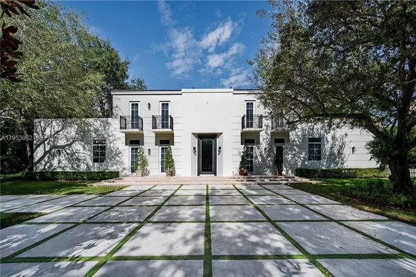 a view of a white house with a yard