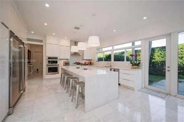 a large kitchen with a table and chairs