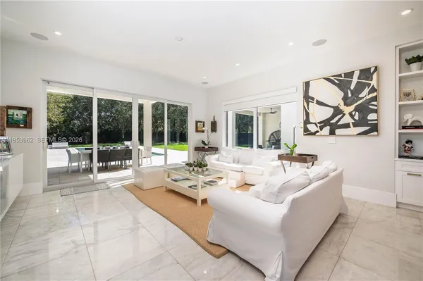 a living room with furniture and a floor to ceiling window