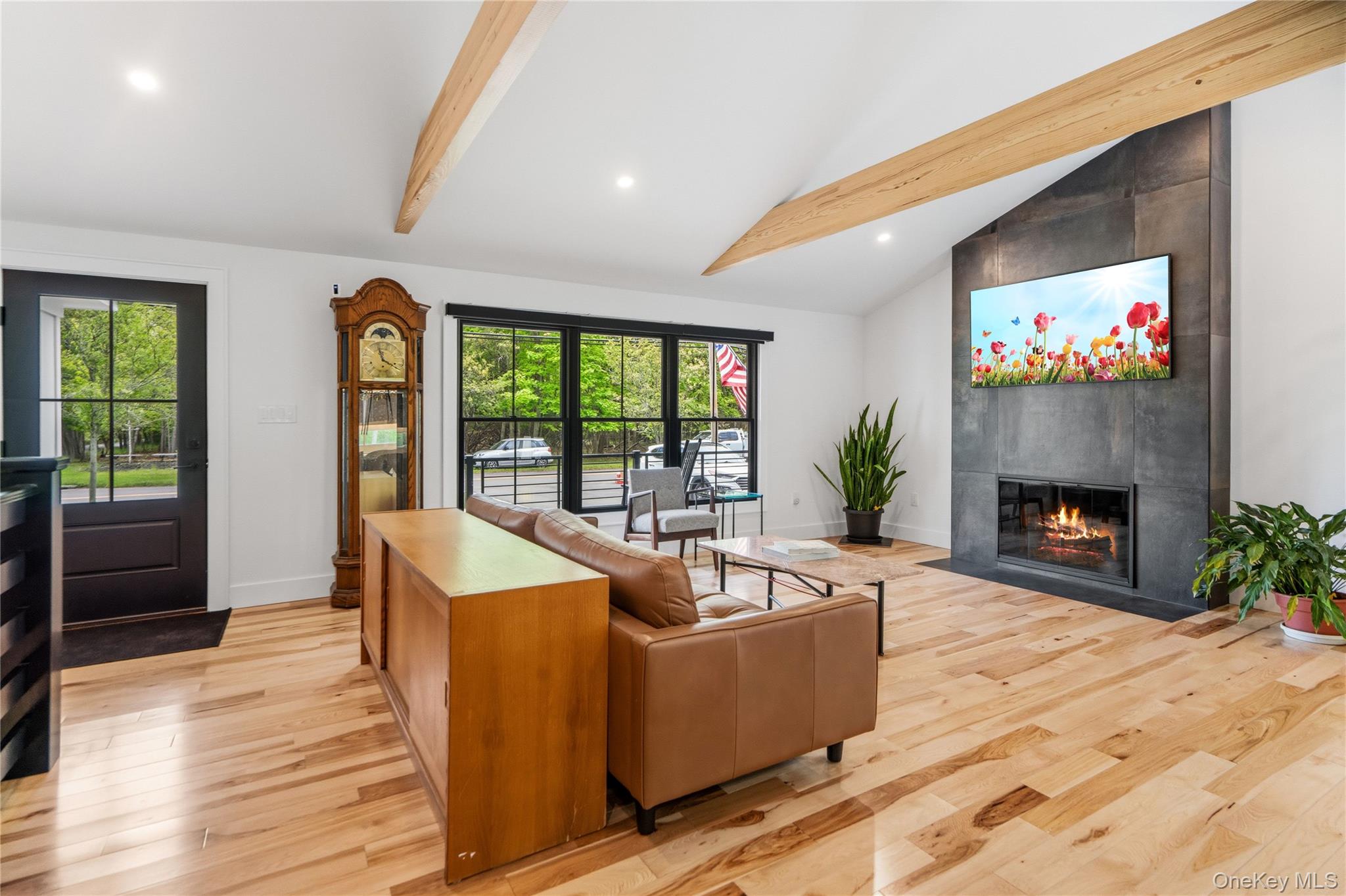 263 Beaver Dam Road Brookhaven, NY 11719 - Photo 5 of 32 a living room with furniture a fireplace and a flat screen tv