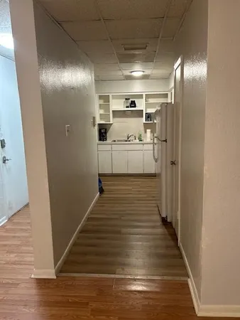 a kitchen with white cabinets and white stainless steel appliances