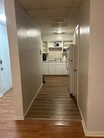 a kitchen with white cabinets and white stainless steel appliances