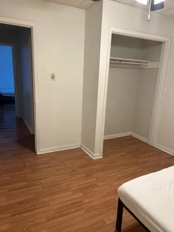 a view of a room with wooden floor and bench