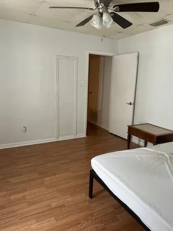 a bedroom with a bed and a ceiling fan