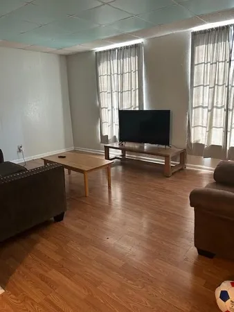 a living room with furniture window and flat screen tv