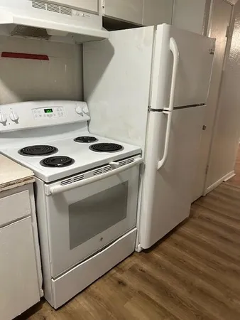 a white refrigerator freezer and a stove sitting inside