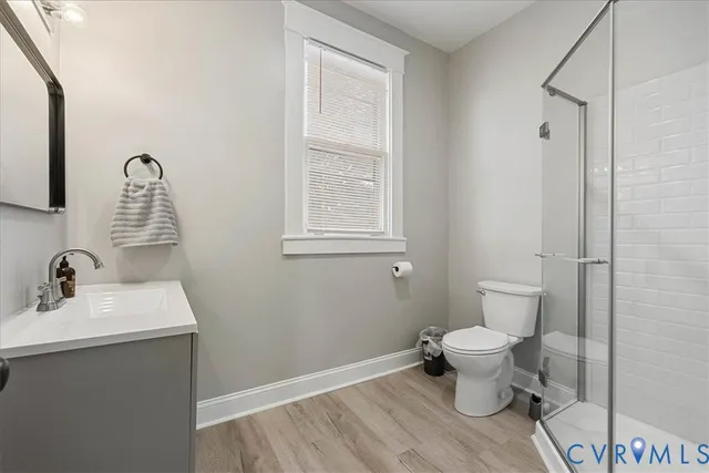 a bathroom with a toilet sink and a mirror