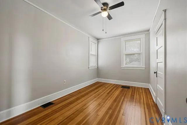 wooden floor in an empty room with a window
