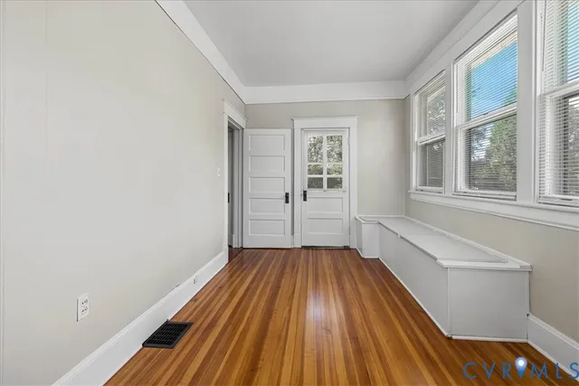 a view of a room with wooden floor and staircase