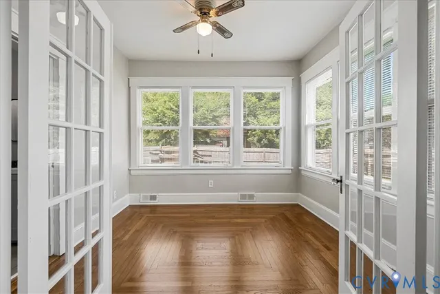 a view of an entryway with wooden floor and a window