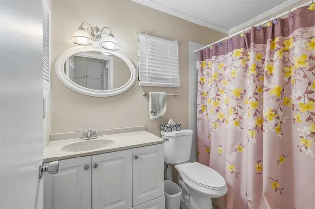 a white toilet sitting next to a bathroom sink