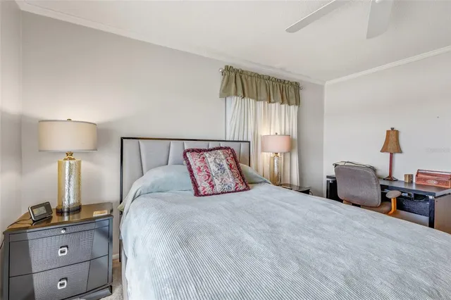 a bedroom with a bed and a lamp on dresser