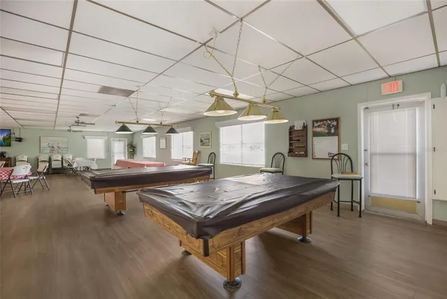 a large kitchen with stainless steel appliances granite countertop a sink and a refrigerator