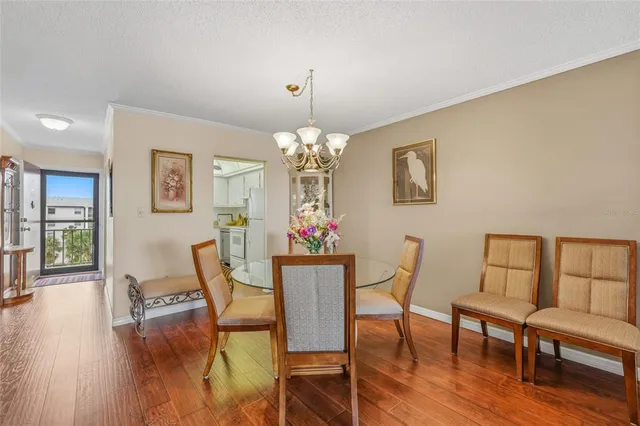 a view of a dining room with furniture wooden floor and chandelier