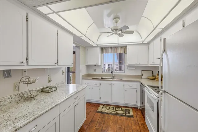 a kitchen with a sink cabinets and window