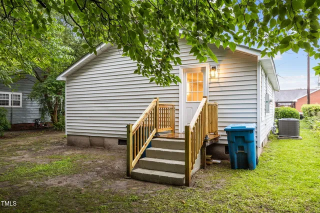 a view of a house with backyard and a chair