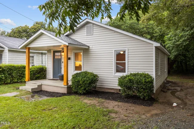 a view of a house with a yard and plants