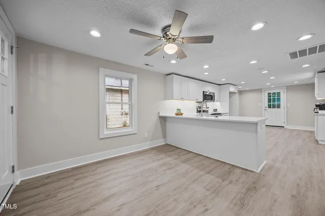 a view of kitchen with cabinets and wooden floor