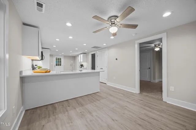 a view of kitchen with wooden floor and window