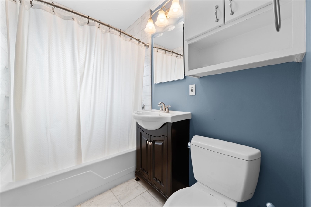 26 Westgate Road, Unit 264 Chestnut Hill, MA 02467 - Photo 14 of 30 a white toilet sitting next to a bathroom sink