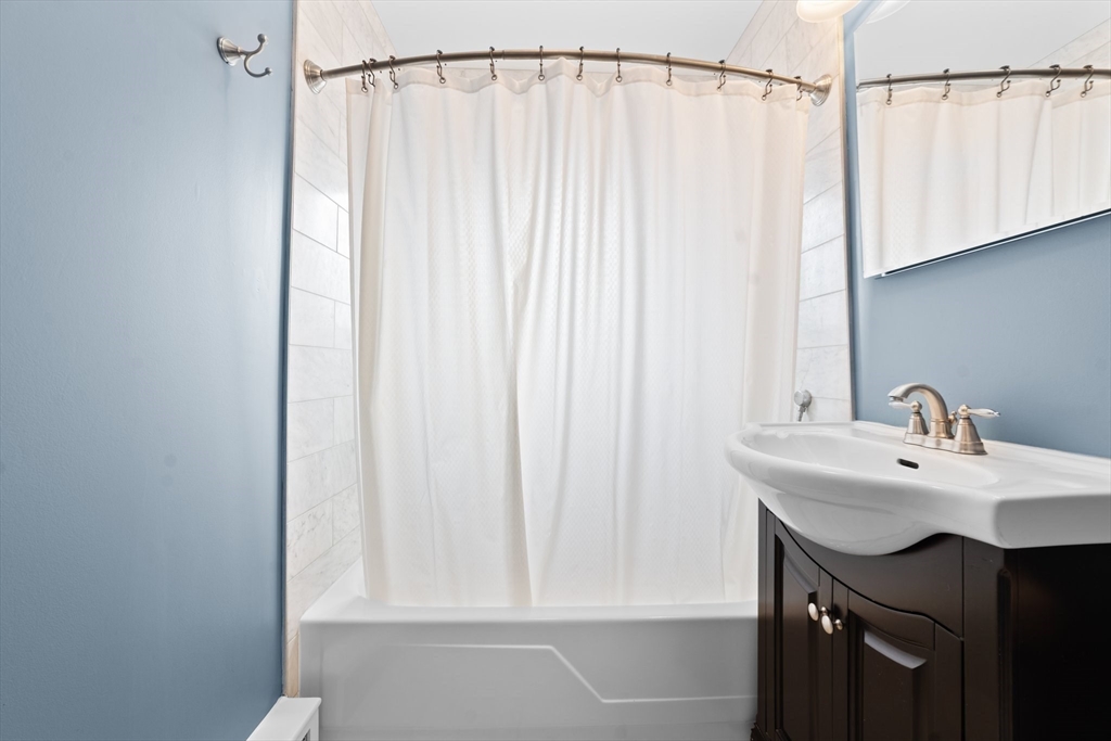 26 Westgate Road, Unit 264 Chestnut Hill, MA 02467 - Photo 15 of 30 a bathroom with a sink and a mirror